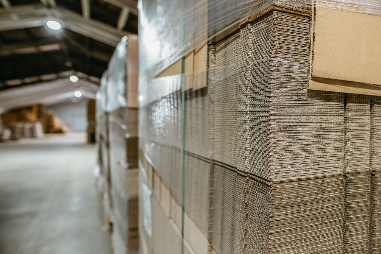 Folding cardboard boxes. Perforated sheets of corrugated cardboard a stack on pallets. Packaging of finished products in industrial production.