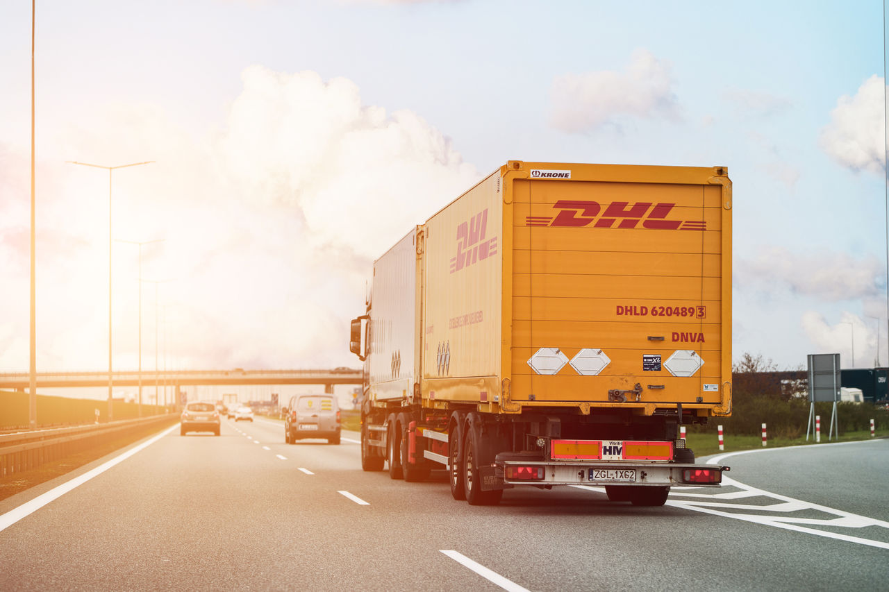 Germany Europe - 15.04.2023 DHL truck on the highway. Lorry belonging to the international courier, parcel and express mail service DHL